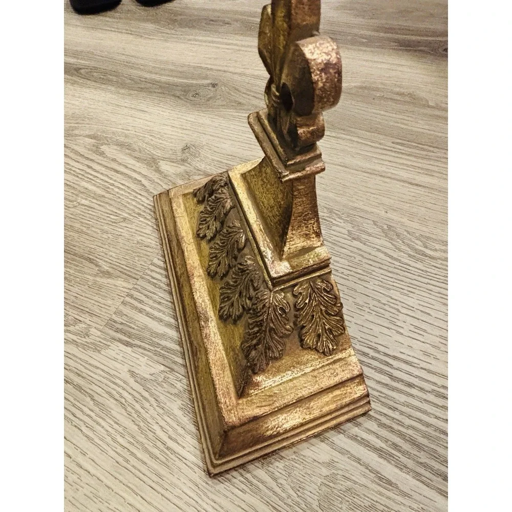 Vintage gold-toned decorative wall shelves with floral motifs.